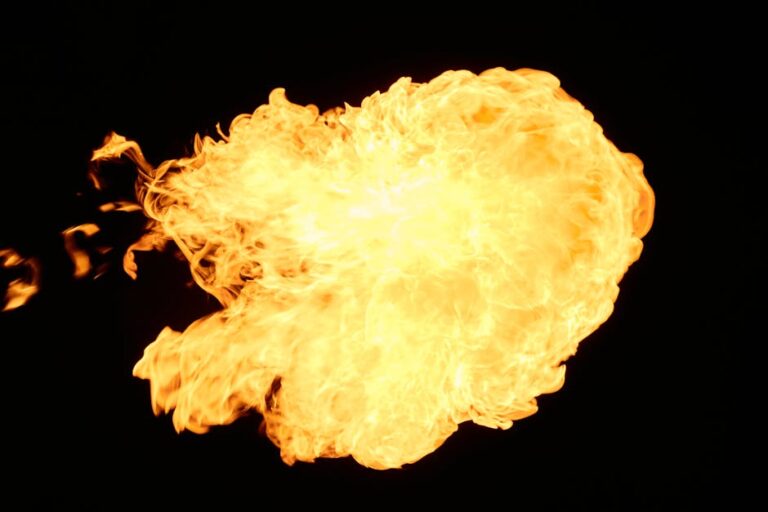 Vivid fireball explosion with flames and heat on a contrasting black backdrop.