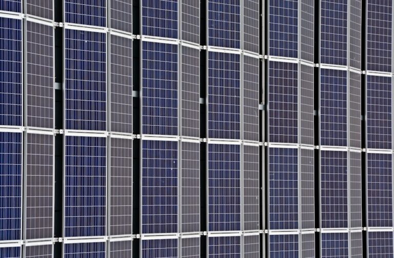 Close-up of multiple solar panels representing renewable energy and sustainability.