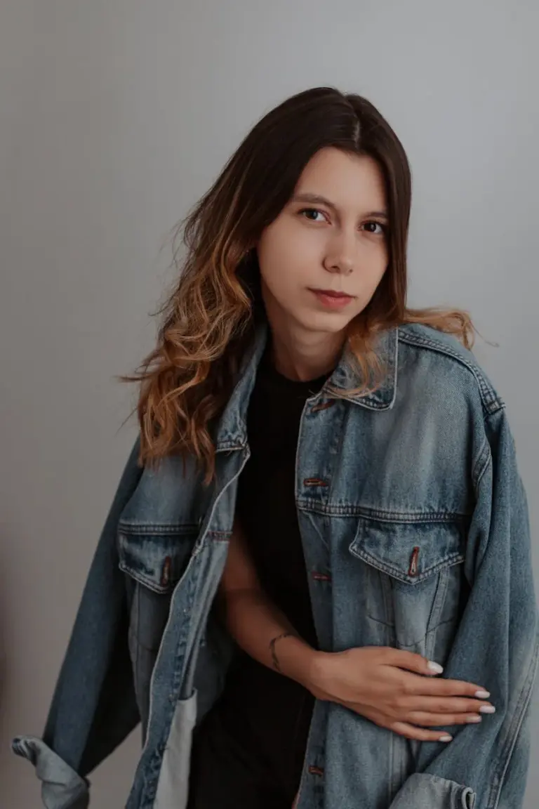 Casual and stylish portrait of a young woman in a trendy denim jacket.