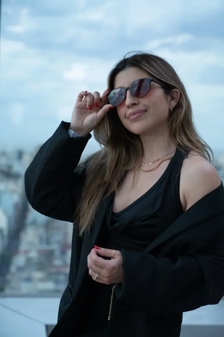 Fashionable woman with sunglasses posing on a rooftop in Buenos Aires, Argentina.