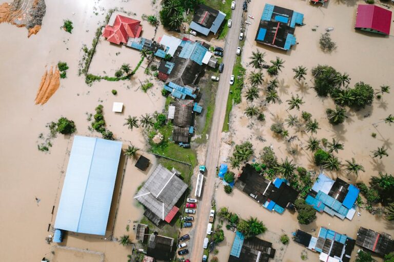 Drone view of a residential area in Kijal, Malaysia, showing extensive flooding and submerged buildings.